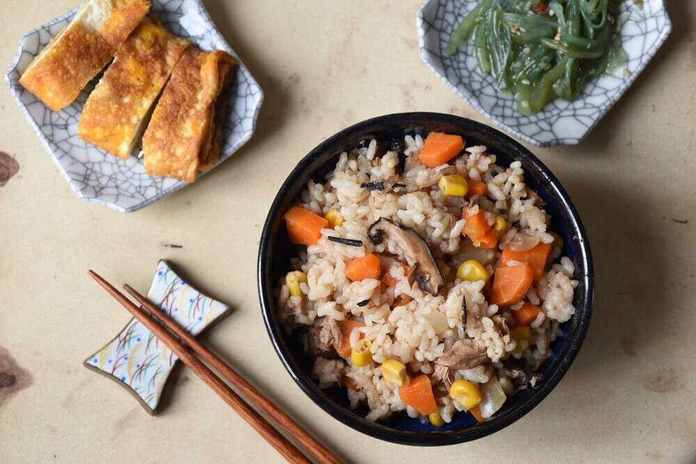 炊き込みご飯とおかずの載った食卓