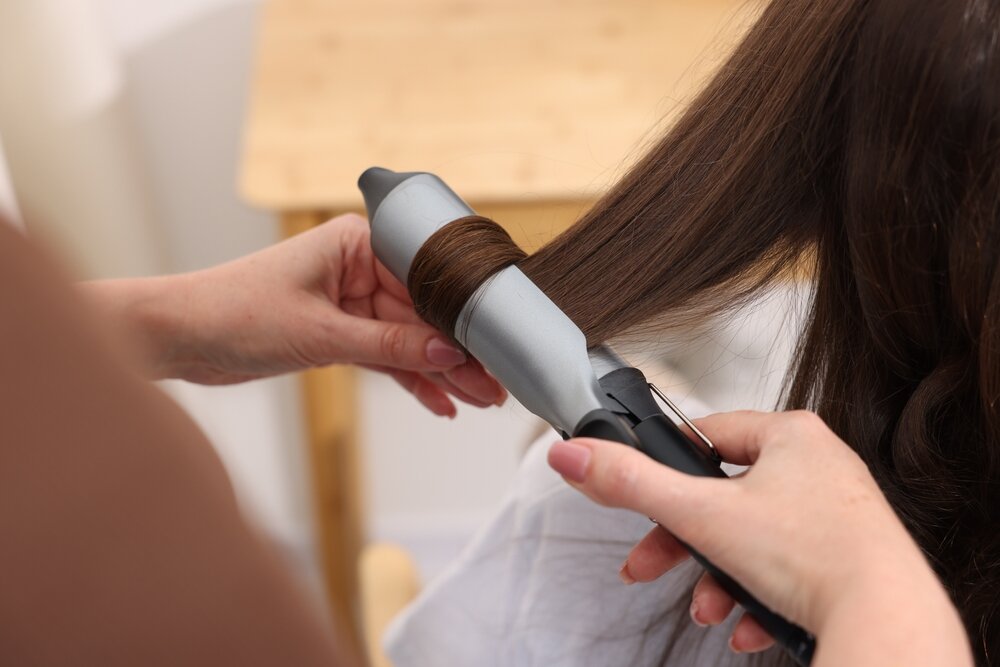 ヘアアイロンで髪を巻く様子