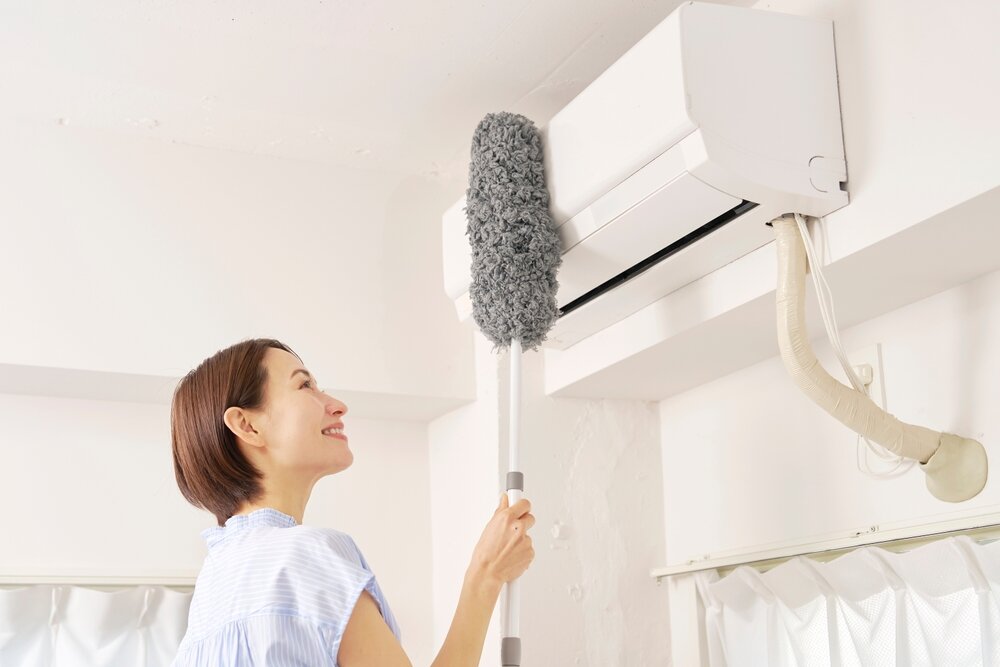 エアコンを掃除する女性