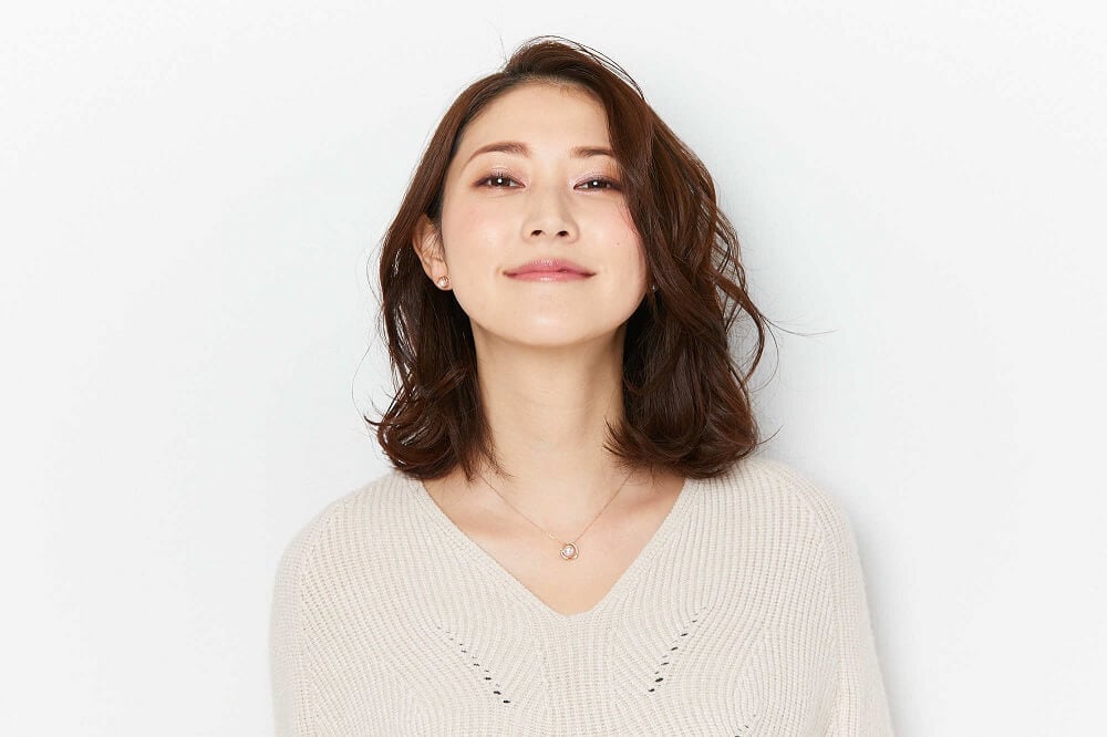 ４℃のネックレスを身に着ける女性