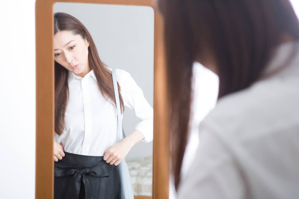 鏡をのぞき込む女性