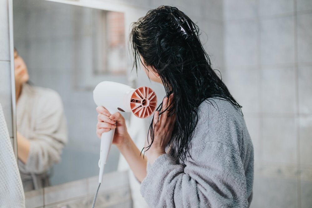 ドライヤーをしている女性の写真